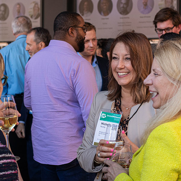 A group of people at a networking event smiling.